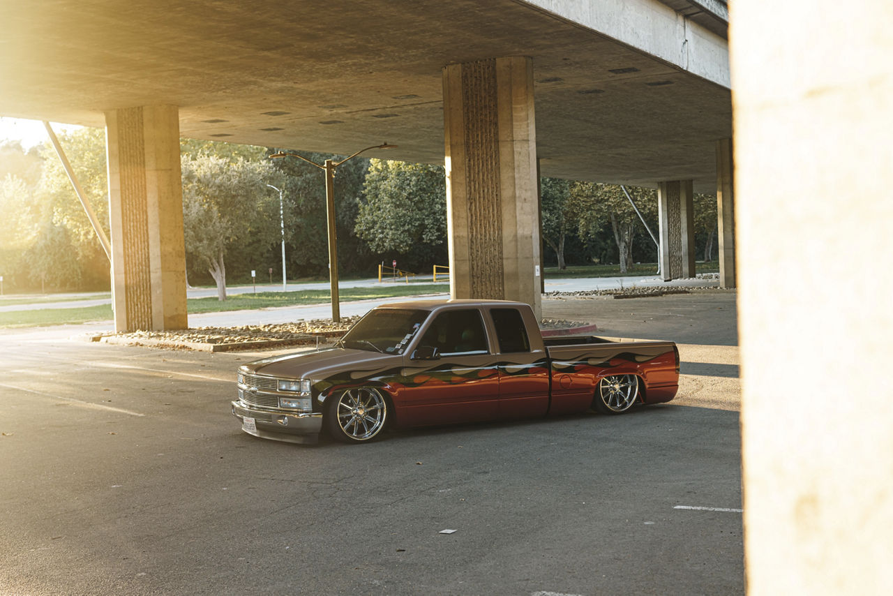 Lowered 1994 Chevrolet Silverado on chrome US Mags Rambler wheels and 305/35R22 rear tires